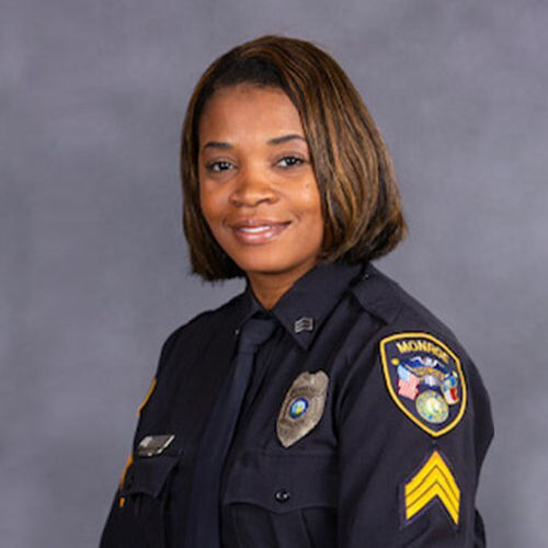 Board member Lt. Holt. is wearing her dress blues and smiles for her headshot. 