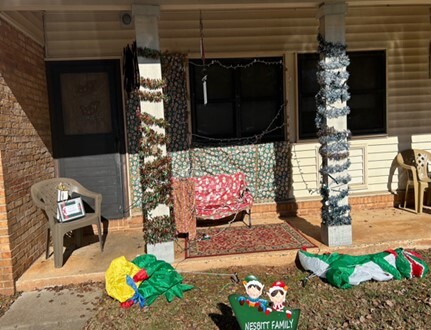 A winning porch and yard with a certificate for the 2024 door contest.